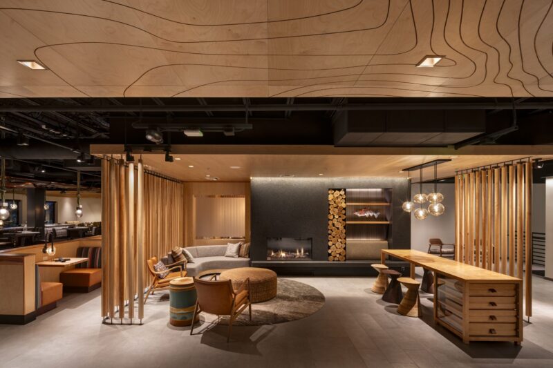 Lobby Seating Fireplace Curved Sofa Wood Detail low res scaled